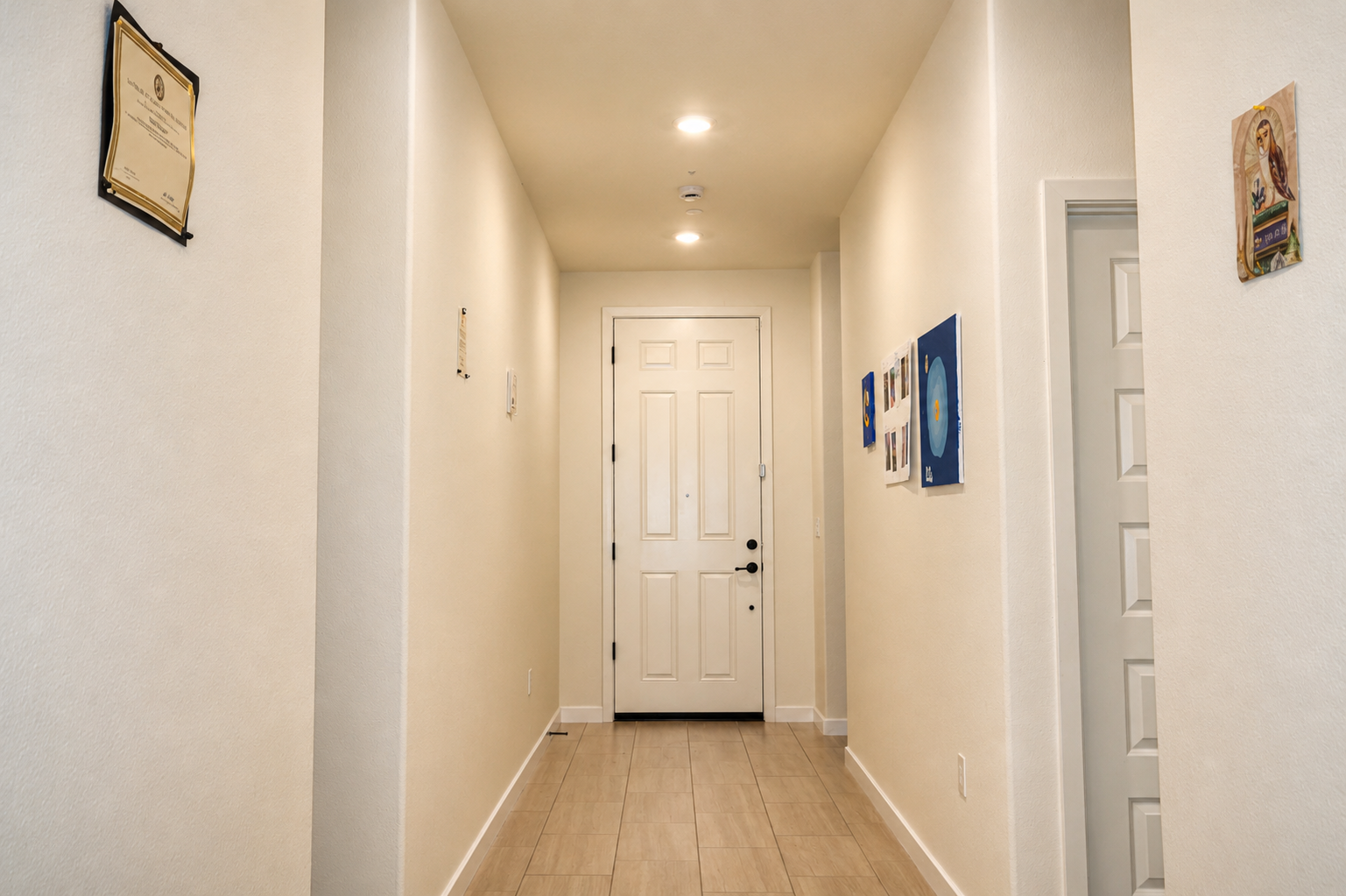 Bright entry hallway with tile flooring