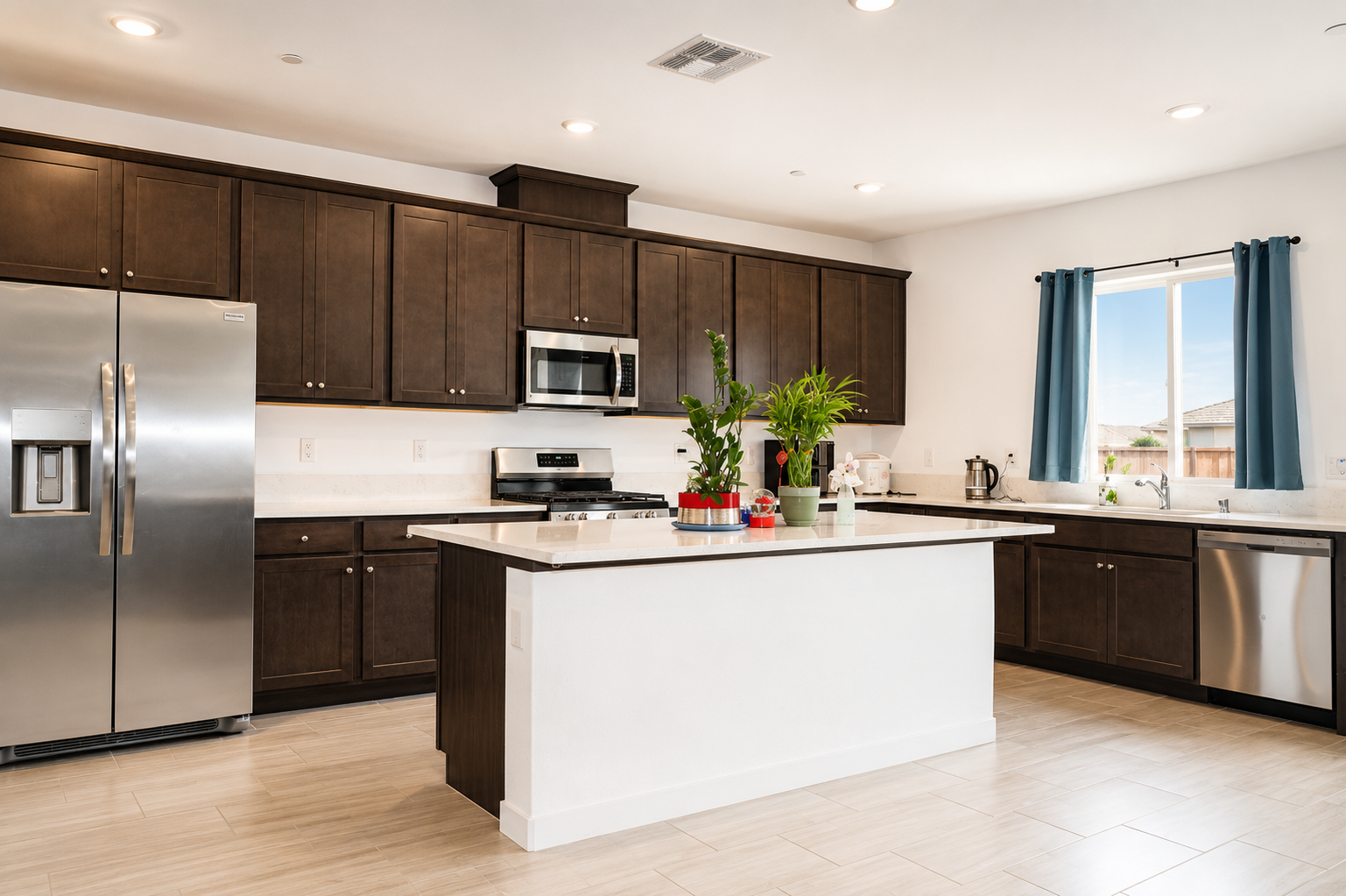 Chef's kitchen with quartz island and stainless appliances